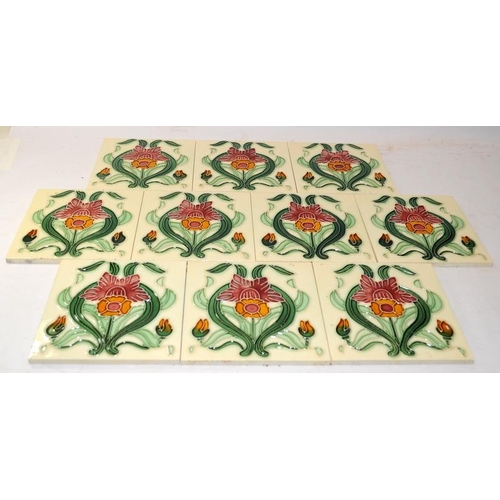 33 - 10 x tubeline ceramic tiles in an Art Deco style on an ivory ground. All the same design