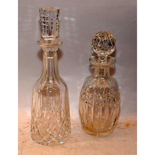 21 - Two crystal glass decanters, the larger 34cms decanter being Waterford Crystal in the Lismore patter... 