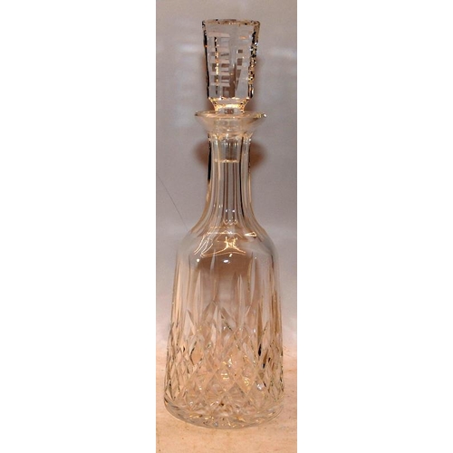 21 - Two crystal glass decanters, the larger 34cms decanter being Waterford Crystal in the Lismore patter... 