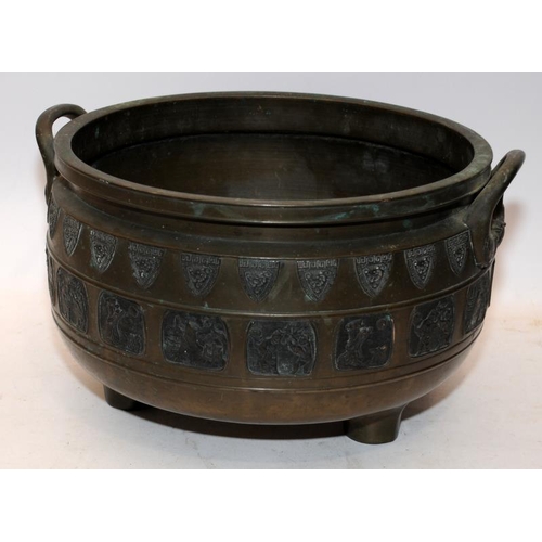 61 - Large 19thC Oriental bronze bowl on three feet with pictorial panel decoration. 37cms across