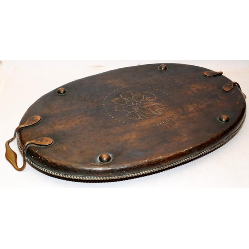 64 - Arts and Crafts large oval planished finish copper tray with handles by Hugh Wallis. 63cms across. L... 