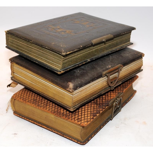 197 - Three antique photograph albums containing a good quantity of photographs and postcards