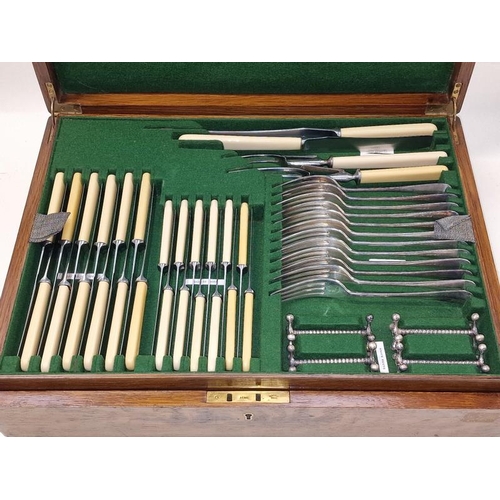 413 - Antique quality two tiered oak cutlery canteen containing a complete set of silver plated flatware f... 