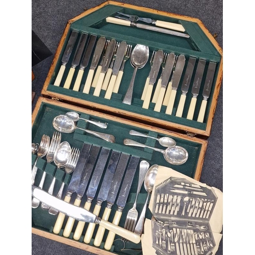 414 - Two vintage wooden cutlery canteens containing complete sets of silver plated flatware.