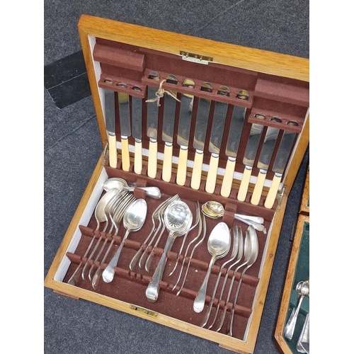 414 - Two vintage wooden cutlery canteens containing complete sets of silver plated flatware.