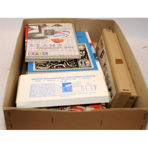 214 - Collection of stamps related items to include reference books, mounting cards, vintage watermark det... 