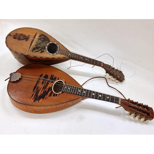 231 - A pair of antique mandolins with decorative mother of pearl inlay.