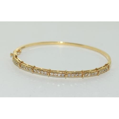 204 - A 14ct Gold & Diamond set Hinged Bangle. Approx 0.5ct,  9.4g, ref W