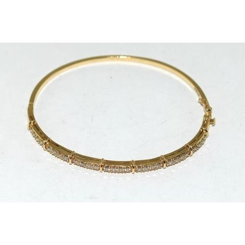 204 - A 14ct Gold & Diamond set Hinged Bangle. Approx 0.5ct,  9.4g, ref W