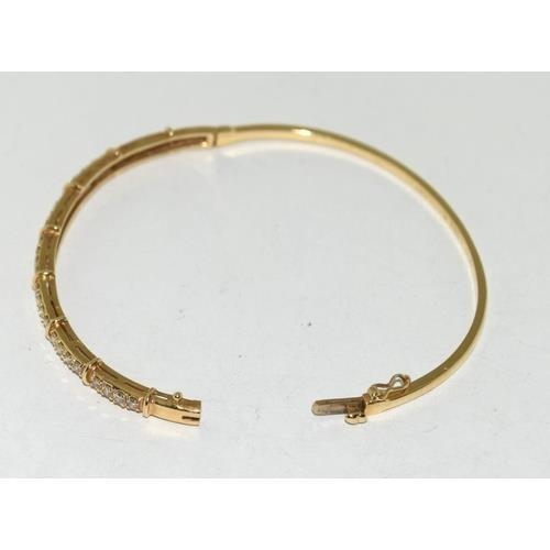 204 - A 14ct Gold & Diamond set Hinged Bangle. Approx 0.5ct,  9.4g, ref W