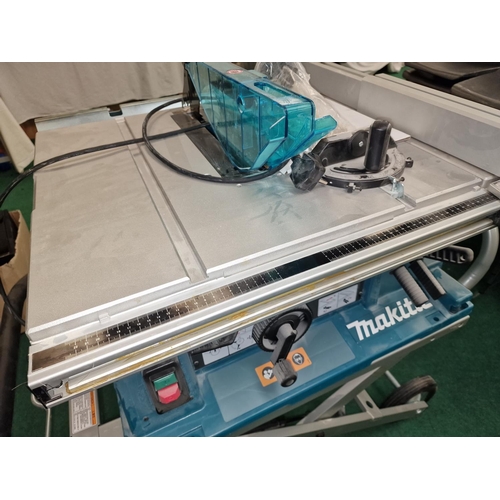 331 - Makita 2704N table saw with Makita branded stand in brand new unused condition.