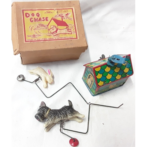 477 - Dog Chase (Japan) tinplate wind up toy in box together with British made tinplate Rabbit pulling a c... 