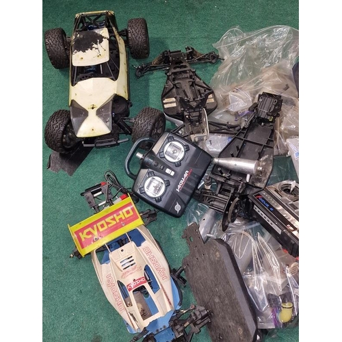 233 - Large collection of Remote Controlled car spare parts to include shells, engines, controllers etc.