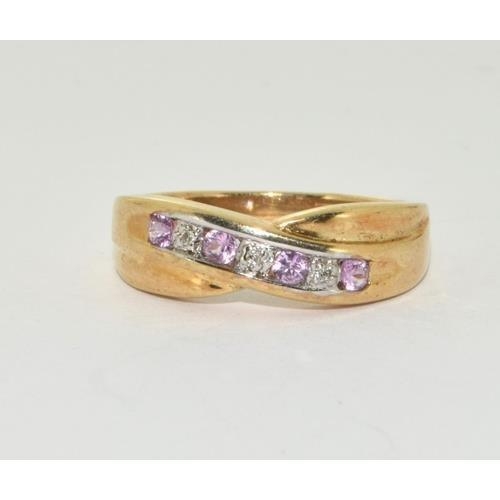 356 - 9ct gold ladies diamond and Pink Tourmaline cross over ring size M