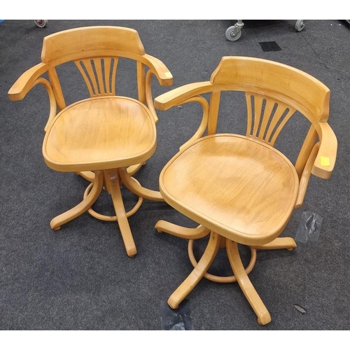 575 - A pair of elm swivel chairs.