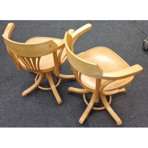 575 - A pair of elm swivel chairs.