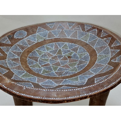 580 - Wooden tribal design side table with internal decoration 37cm tall.