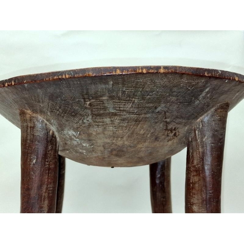 580 - Wooden tribal design side table with internal decoration 37cm tall.