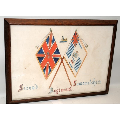 119 - Framed pen and ink depicting the colours of the Second Somersetshire Regiment, c/w a trench art toba... 