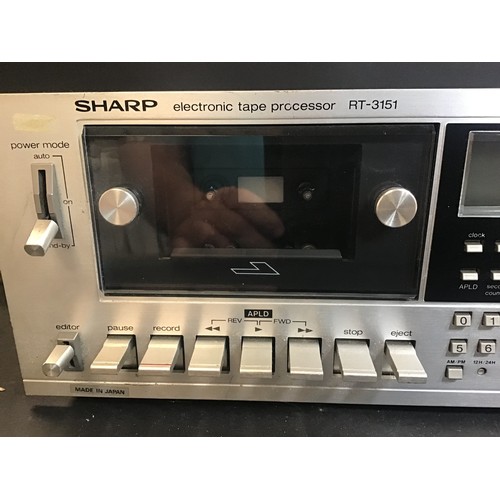 599 - SHARP STEREO CASSETTE DECK. Model No. RT-3151 which powers up and tape turns with VU meters moving.