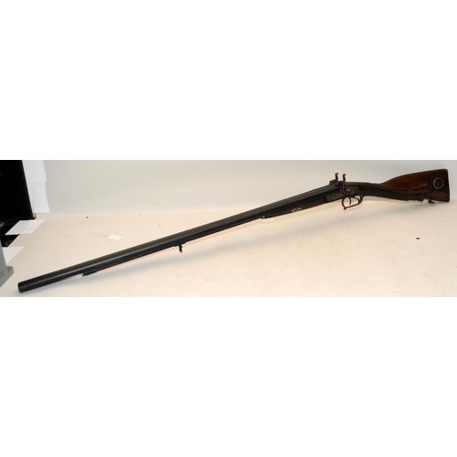 142 - Antique double barrel two trigger shotgun with ornately carved stock. O/all length 122cms. Mechanism... 