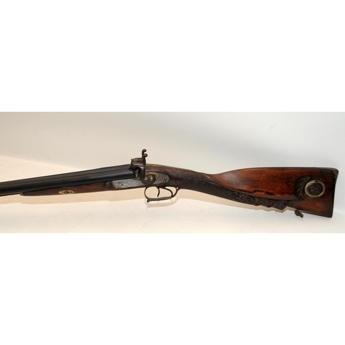 142 - Antique double barrel two trigger shotgun with ornately carved stock. O/all length 122cms. Mechanism... 