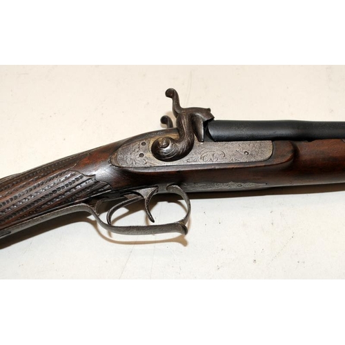 142 - Antique double barrel two trigger shotgun with ornately carved stock. O/all length 122cms. Mechanism... 