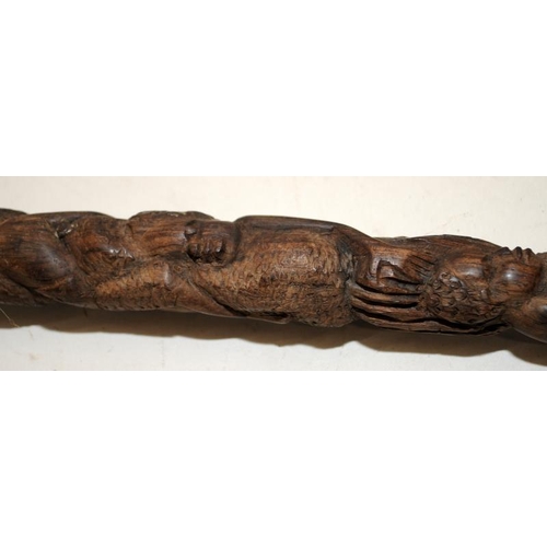 236 - Two early African carved hardwood walking canes, each around 85cms long