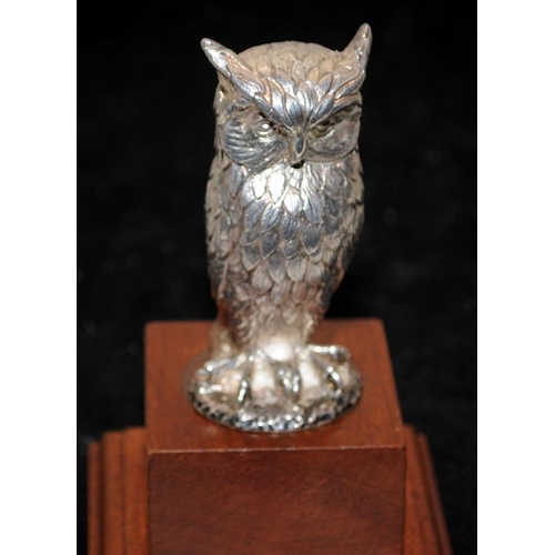 262 - Hallmarked sterling silver Owl mounted on a wooden stepped plinth. Not filled 137g silver weight, o/... 