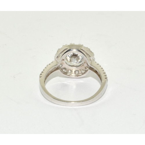 389 - A sparkling 925 silver halo style ring Size M