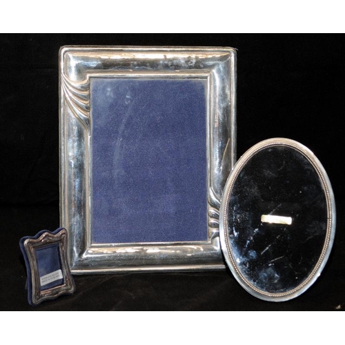 292 - Three hallmarked sterling silver picture frames, the largest being 18cms x 24cms