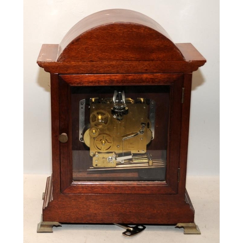 376 - Oak cased chiming mantel clock 'Tempus Fugit'. 38.5cms tall. Seen working at time of listing