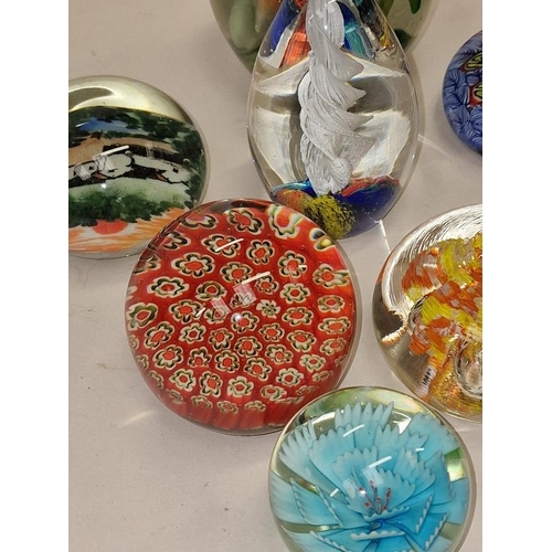 110 - A collection of decorative glass paperweights (18).