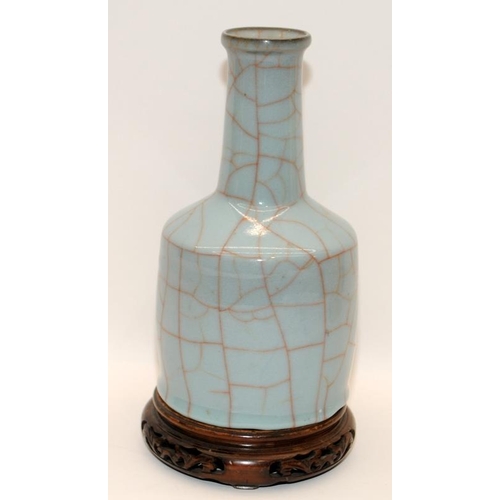 3 - A heavily potted Oriental type crackle glazed blue mallet vase with wood stand, H27cm (signs of wear... 