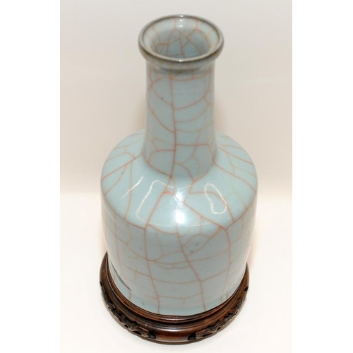 3 - A heavily potted Oriental type crackle glazed blue mallet vase with wood stand, H27cm (signs of wear... 