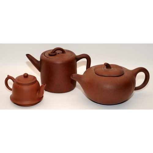 7 - Three Chinese oriental Yixing pottery brown teapots, two of the having marks to the undersides. The ... 