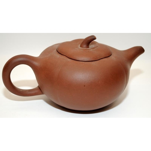 7 - Three Chinese oriental Yixing pottery brown teapots, two of the having marks to the undersides. The ... 