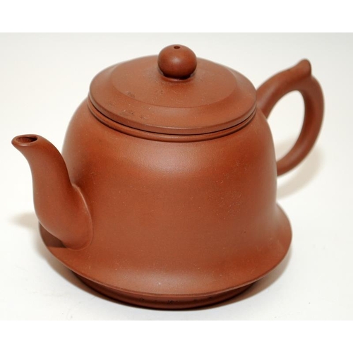 7 - Three Chinese oriental Yixing pottery brown teapots, two of the having marks to the undersides. The ... 