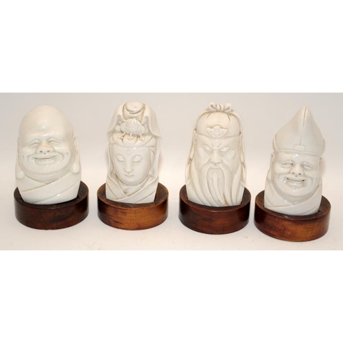 32 - A set of four Chinese 19th/20th century blanc de chine busts comprising two Buddhas, Guanyin & an im... 