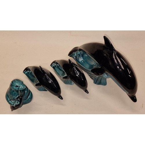 49 - Poole Pottery collection of blue glazed animals to include three dolphins and a seal (4).