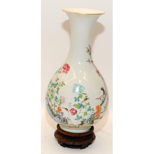 54 - A Chinese Famille rose pear shaped vase, painted in poly chrome enamels with prunus trees and cranes... 