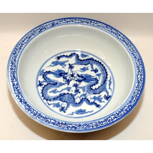 93 - Large Chinese blue and white porcelain basin decorated with twin five claw dragons chasing pearl amo... 