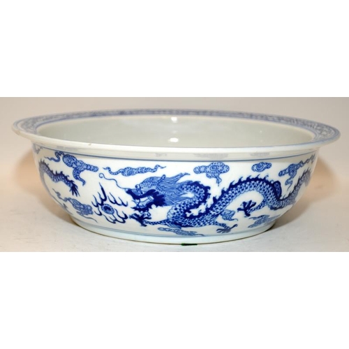 93 - Large Chinese blue and white porcelain basin decorated with twin five claw dragons chasing pearl amo... 