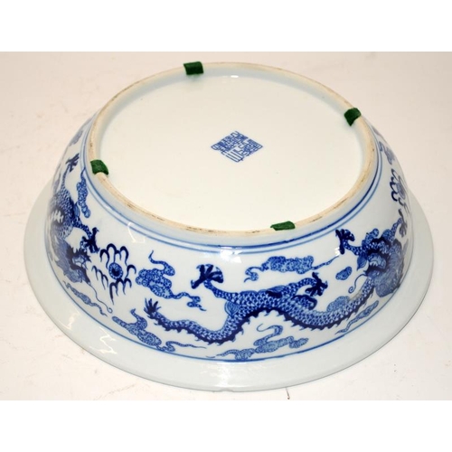 93 - Large Chinese blue and white porcelain basin decorated with twin five claw dragons chasing pearl amo... 