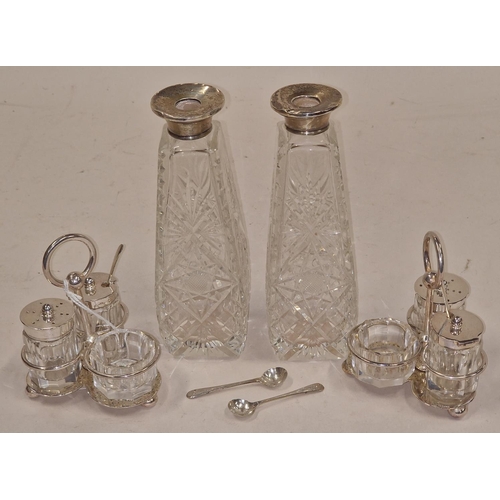 211 - Pair of vintage silver topped crystal glass bottles together with two vintage silver plated condimen... 