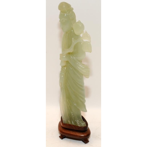 101 - Chinese celadon Jade figure of Kwanyin holding a branch of peaches on original fitted hardwood stand... 