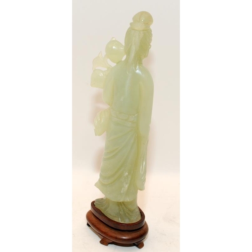 101 - Chinese celadon Jade figure of Kwanyin holding a branch of peaches on original fitted hardwood stand... 