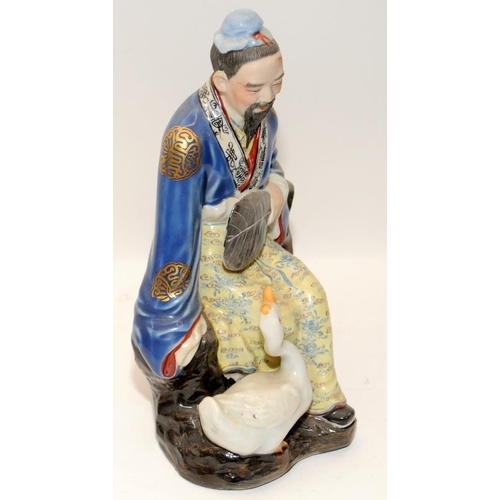 123 - Two Chinese porcelain statues of immortals, marked, 20th century, H21cm (both in good condition)