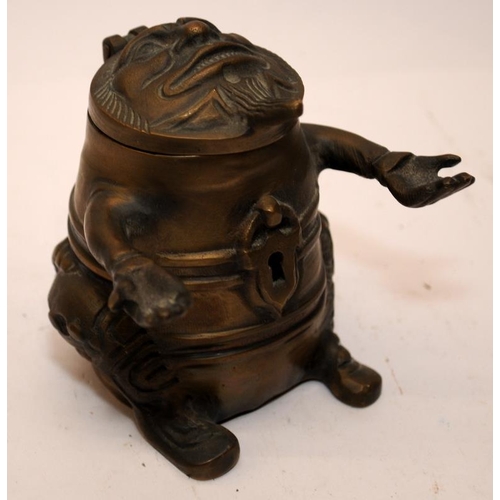 446 - Novelty vintage brass pen holder and inkwell in grotesque form. 9cms tall