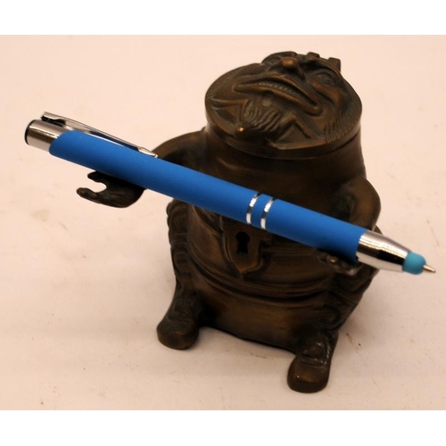 446 - Novelty vintage brass pen holder and inkwell in grotesque form. 9cms tall